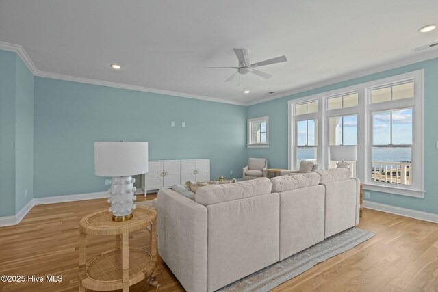 empty room featuring ceiling fan, crown molding, and light hardwood / wood-style flooring