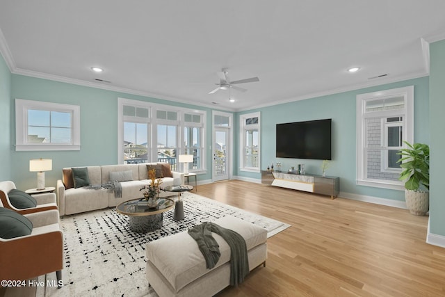 living room featuring light hardwood / wood-style flooring, ceiling fan, and ornamental molding