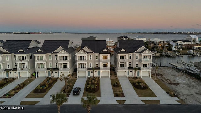 aerial view at dusk with a water view