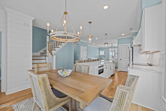 kitchen featuring sink, white cabinetry, custom exhaust hood, and electric stove