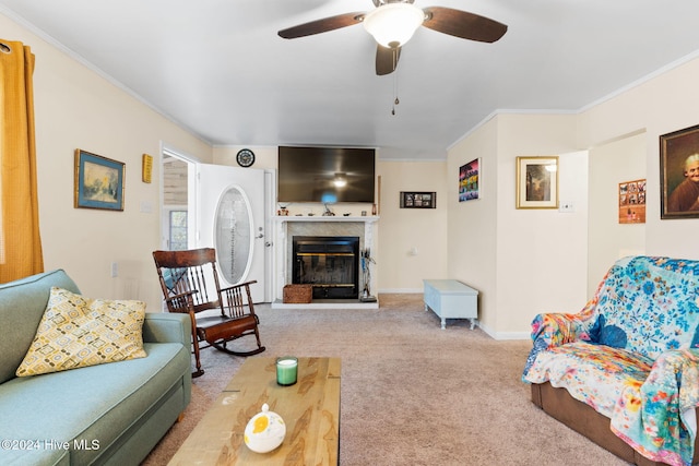 living room with carpet, ceiling fan, and ornamental molding