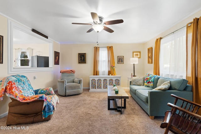 carpeted living room with ceiling fan