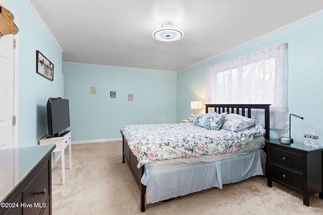 bedroom featuring light colored carpet and ornamental molding