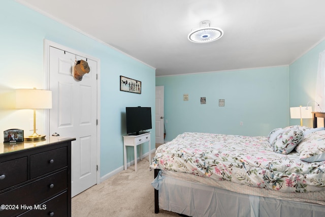 carpeted bedroom featuring crown molding