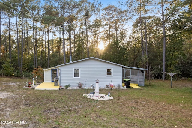 back of property with a lawn