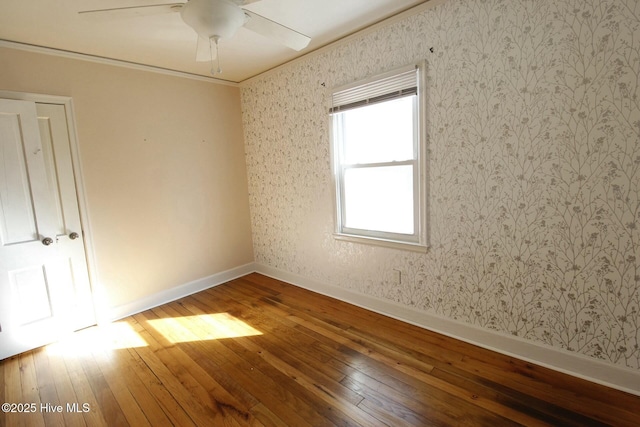 spare room with crown molding, ceiling fan, and hardwood / wood-style flooring