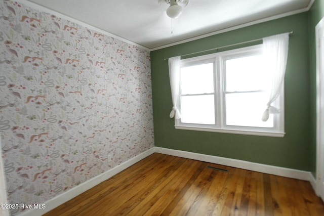 unfurnished room featuring hardwood / wood-style flooring and ornamental molding