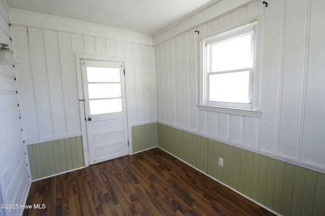 interior space with radiator, wooden walls, and dark hardwood / wood-style floors