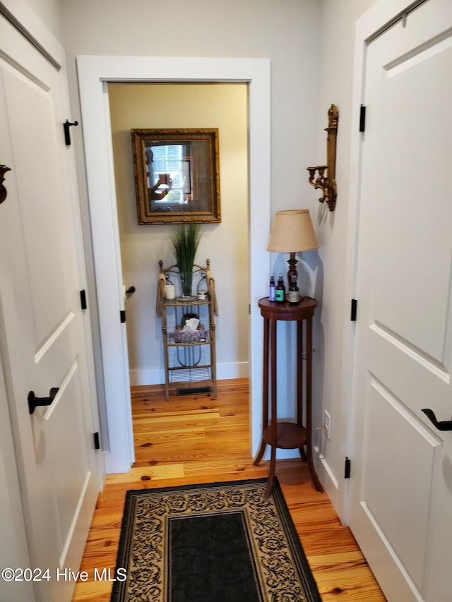 hall with light hardwood / wood-style flooring