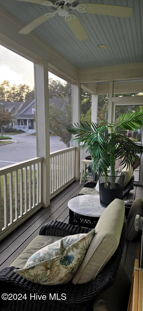 sunroom / solarium featuring ceiling fan and plenty of natural light