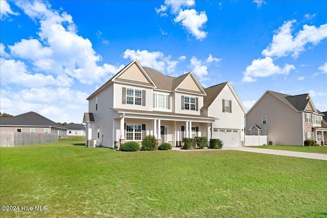 view of front of property with central AC unit, a porch, a garage, and a front yard