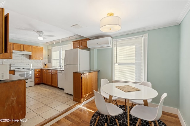 kitchen featuring ceiling fan, a wall mounted air conditioner, crown molding, white appliances, and light tile patterned floors