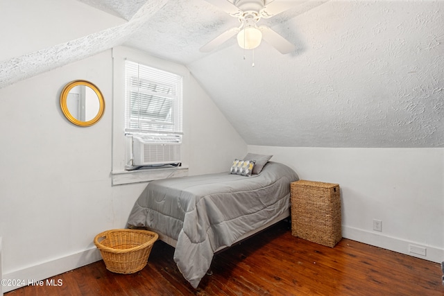 bedroom with lofted ceiling, cooling unit, ceiling fan, a textured ceiling, and dark hardwood / wood-style flooring