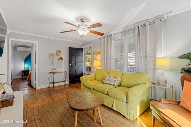 living room with hardwood / wood-style flooring, ceiling fan, and crown molding