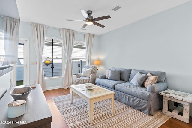 living room with ceiling fan and hardwood / wood-style floors