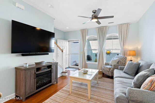 living room featuring ceiling fan and hardwood / wood-style floors