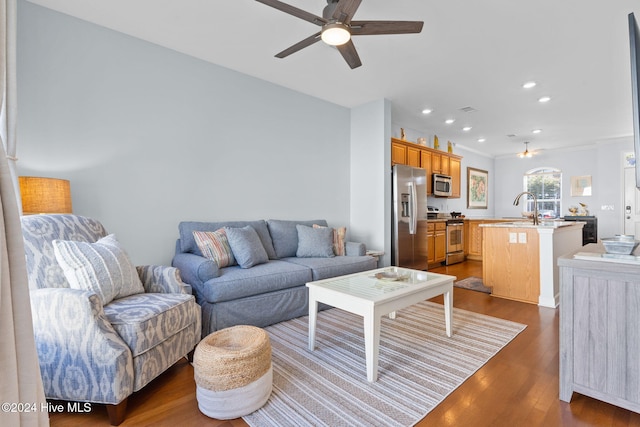 living room with ceiling fan, dark wood-type flooring, and sink