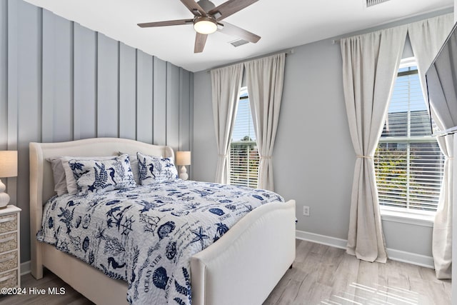 bedroom with ceiling fan and light hardwood / wood-style flooring