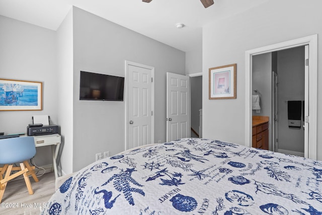 bedroom featuring ceiling fan, connected bathroom, and hardwood / wood-style floors