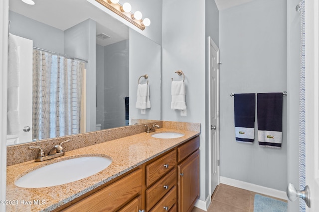 bathroom with tile patterned floors and vanity