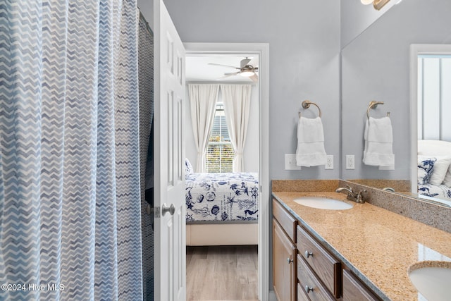 bathroom with hardwood / wood-style flooring, vanity, and ceiling fan