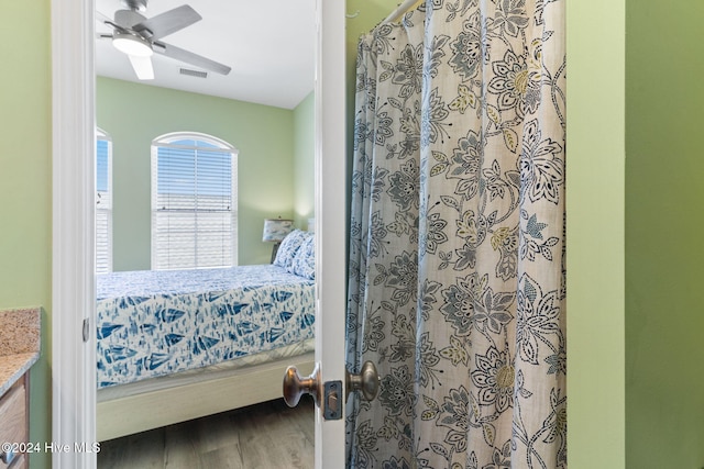 bedroom with ceiling fan and wood-type flooring