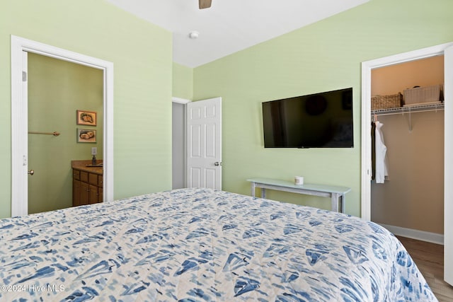 bedroom with wood-type flooring, a closet, and a walk in closet