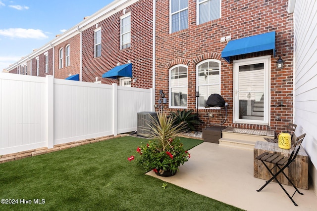 exterior space featuring a lawn and central AC