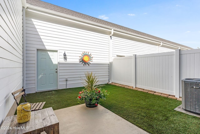 view of yard with cooling unit and a patio area