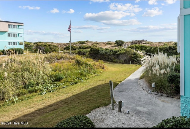 view of home's community featuring a lawn