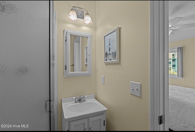 bathroom featuring vanity, a textured ceiling, and ceiling fan