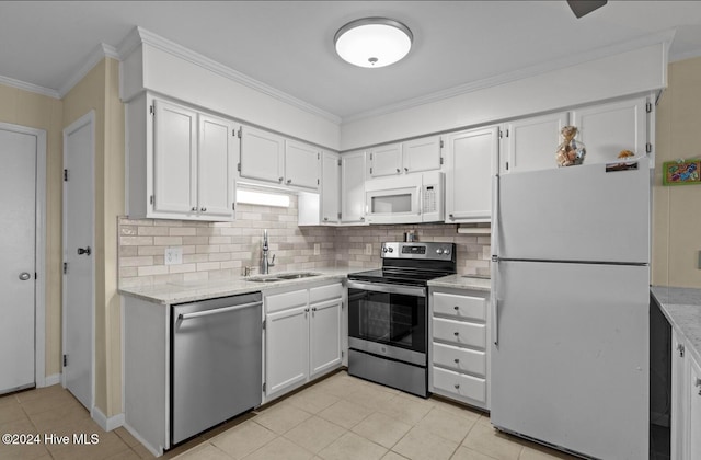 kitchen with tasteful backsplash, sink, stainless steel appliances, white cabinets, and crown molding