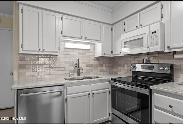 kitchen featuring sink, appliances with stainless steel finishes, crown molding, and white cabinetry