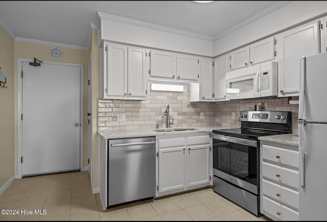 kitchen featuring white cabinets, tasteful backsplash, stainless steel appliances, and sink