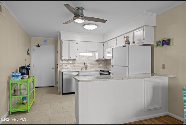 kitchen with decorative backsplash, white cabinets, kitchen peninsula, and white appliances