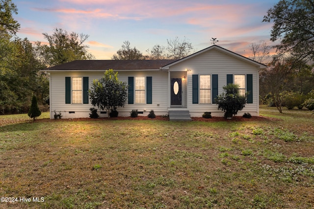 ranch-style house featuring a lawn