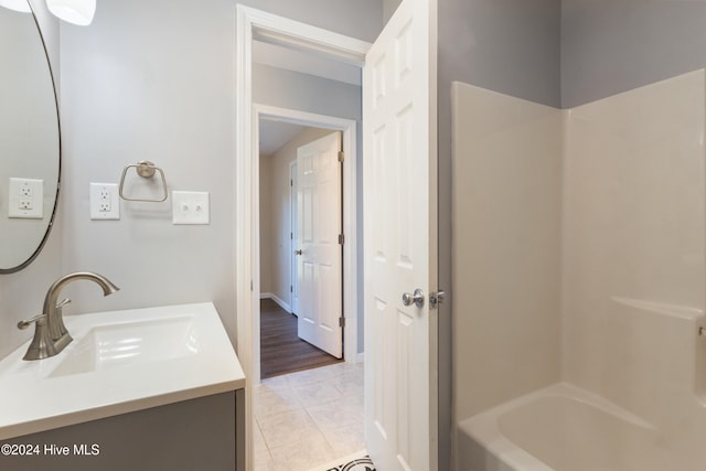 bathroom with vanity, tile patterned floors, and  shower combination