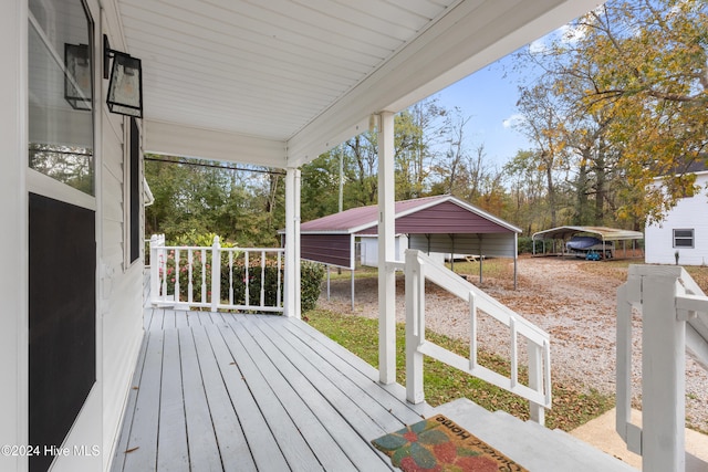 wooden deck with a porch and a carport