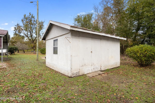 view of outbuilding featuring a yard