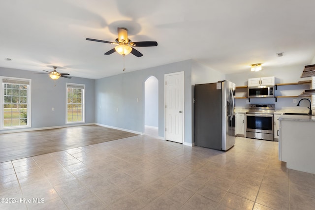 kitchen featuring light hardwood / wood-style flooring, sink, ceiling fan, white cabinetry, and appliances with stainless steel finishes