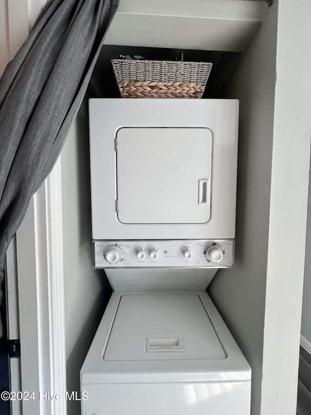 laundry room with stacked washer / drying machine