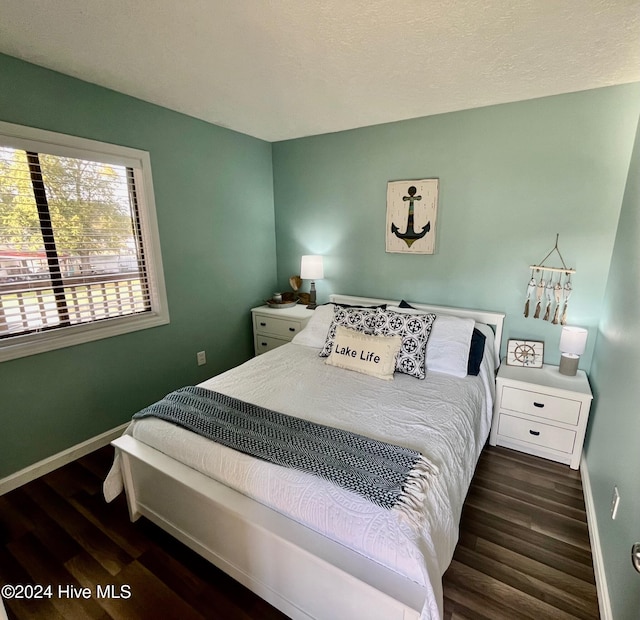 bedroom featuring dark wood-type flooring