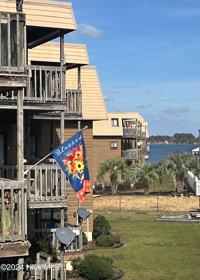 view of building exterior featuring central AC and a water view