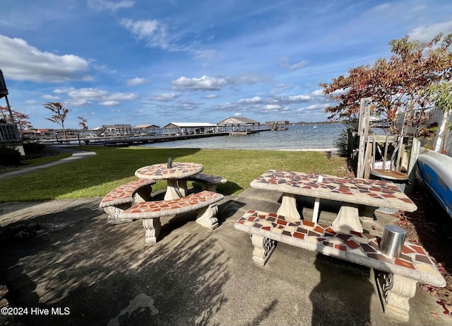 view of yard with a boat dock and a water view