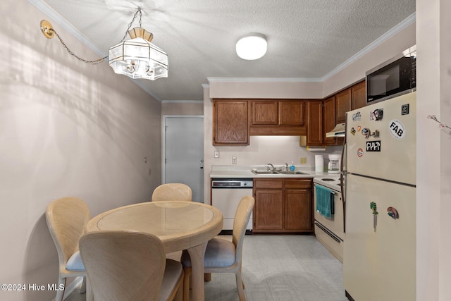 kitchen with white appliances, decorative light fixtures, crown molding, and sink