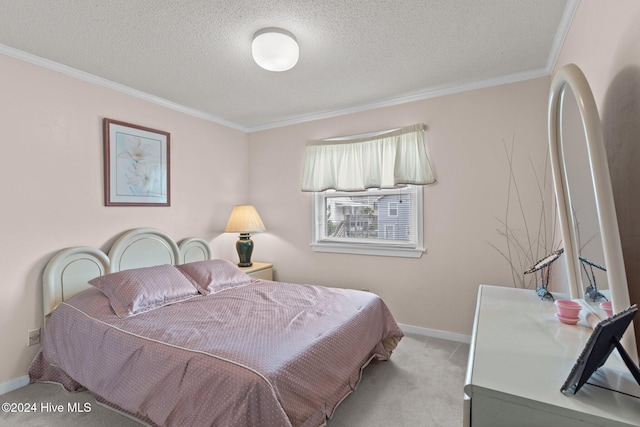 carpeted bedroom with crown molding and a textured ceiling