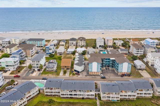 birds eye view of property with a beach view and a water view