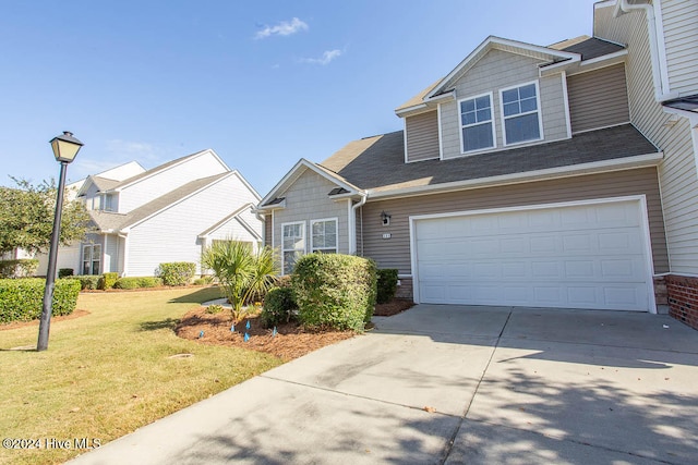 view of front of house featuring a front lawn and a garage