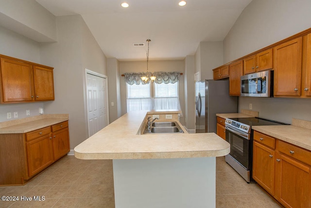 kitchen featuring an island with sink, hanging light fixtures, sink, a chandelier, and appliances with stainless steel finishes