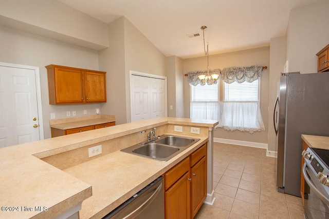 kitchen featuring lofted ceiling, hanging light fixtures, appliances with stainless steel finishes, light tile patterned flooring, and sink